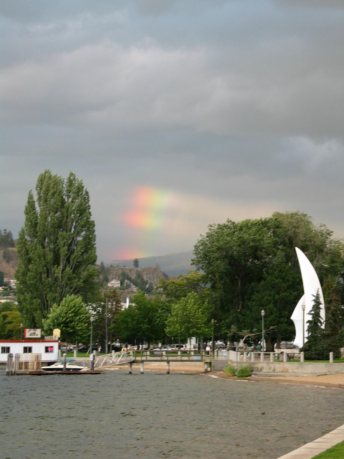 a partial rainbow near the beach