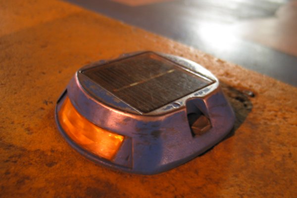 Solar-powered blinking traffic guides