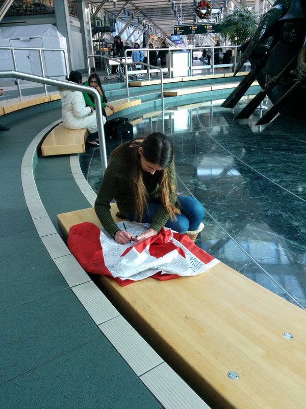 A girl drawing on a Canadian Flag