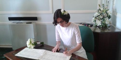 Christina signs the marriage certificate